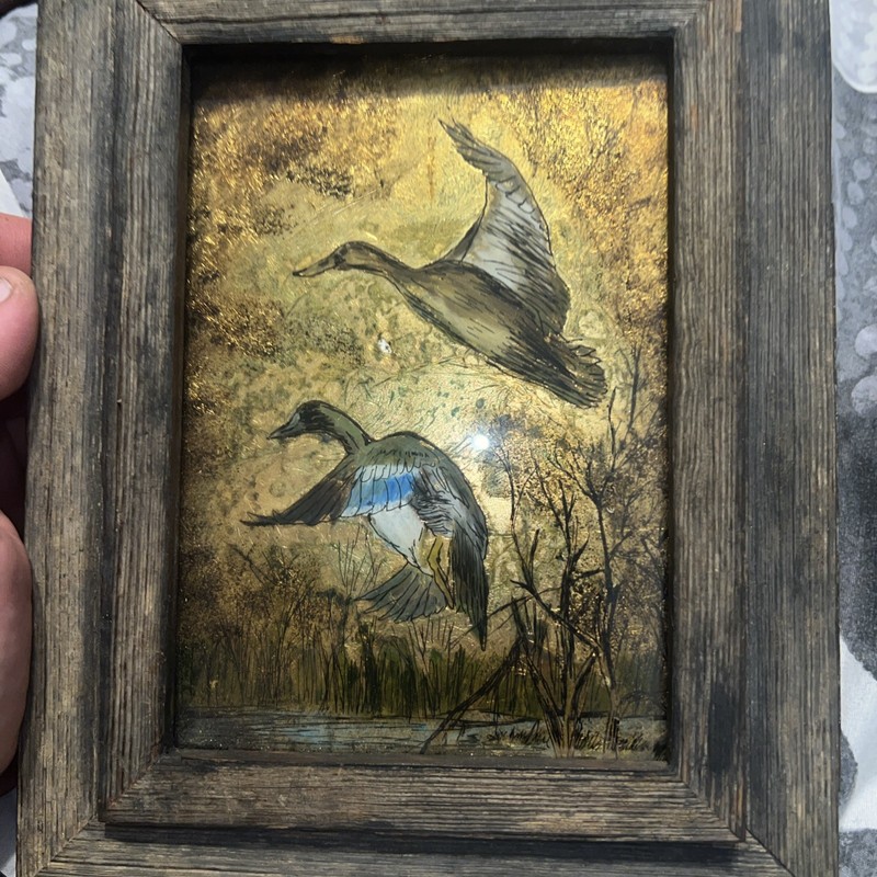 A vintage F. Osborne foil art print of mallard ducks in a rustic wood frame