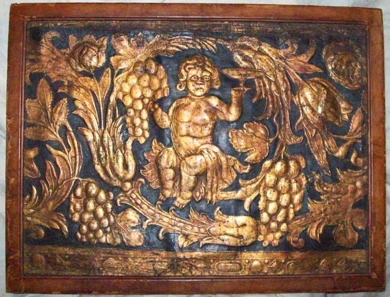 FRAMED ANTIQUE GILDED & EMBOSSED LEATHER PANEL with BACCHUS TOASTING WINE/GRAPES