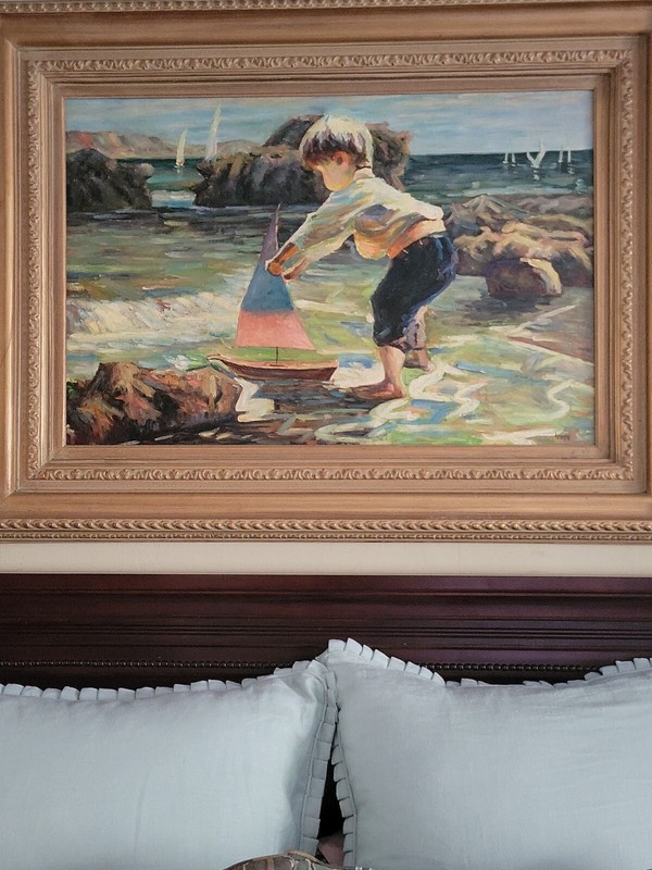 A Boy At The Lake Playing With His Sailboat Painting