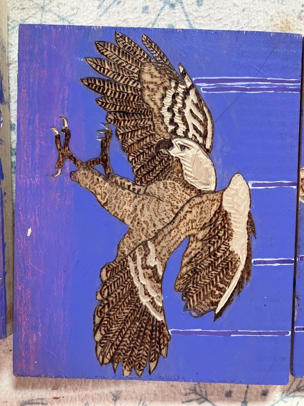 Tryptich hand puppeteering a hawk over a mountain landscape done in wood burning gallery